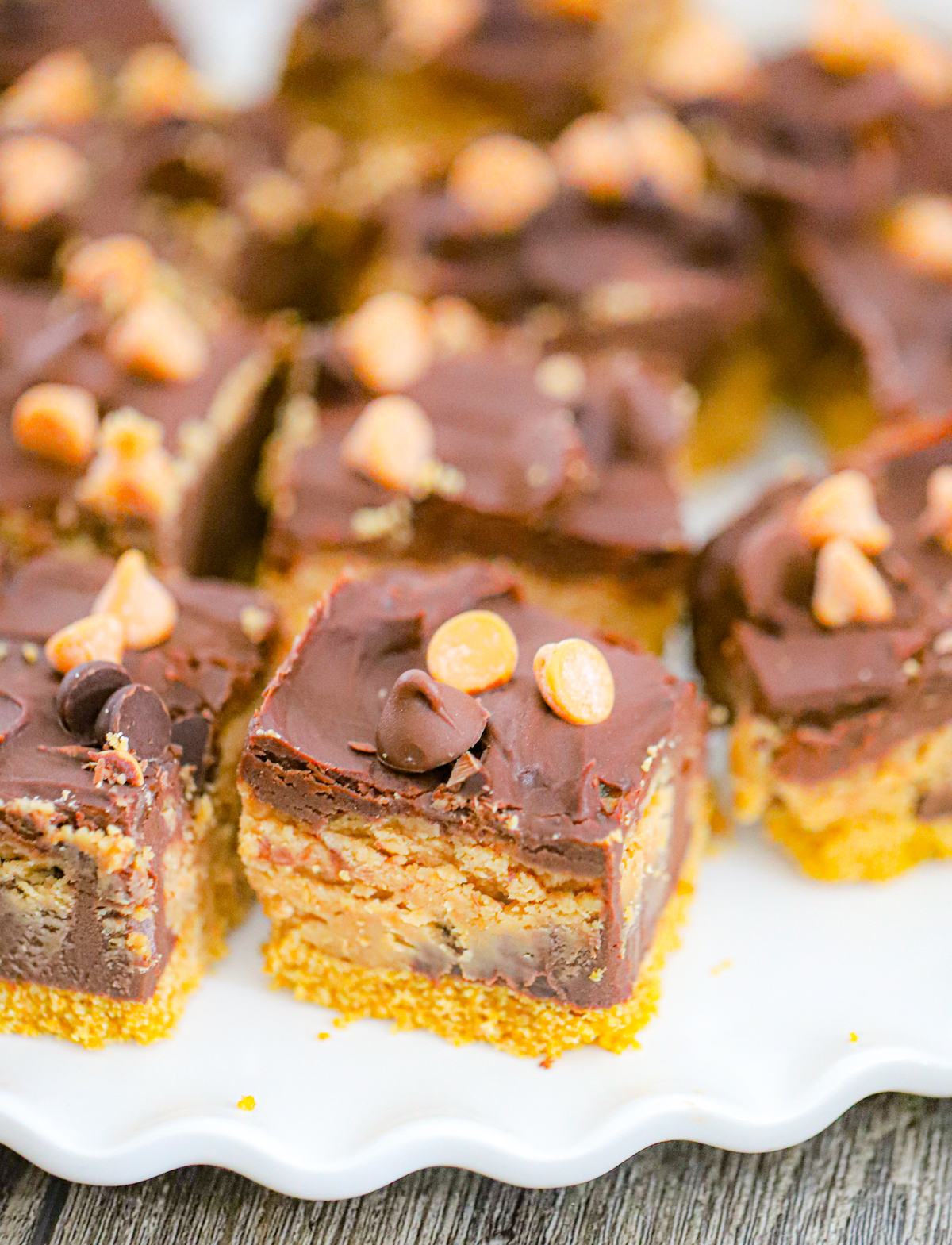 recipe for no bake chocolate peanut butter cheesecake bars on a plate