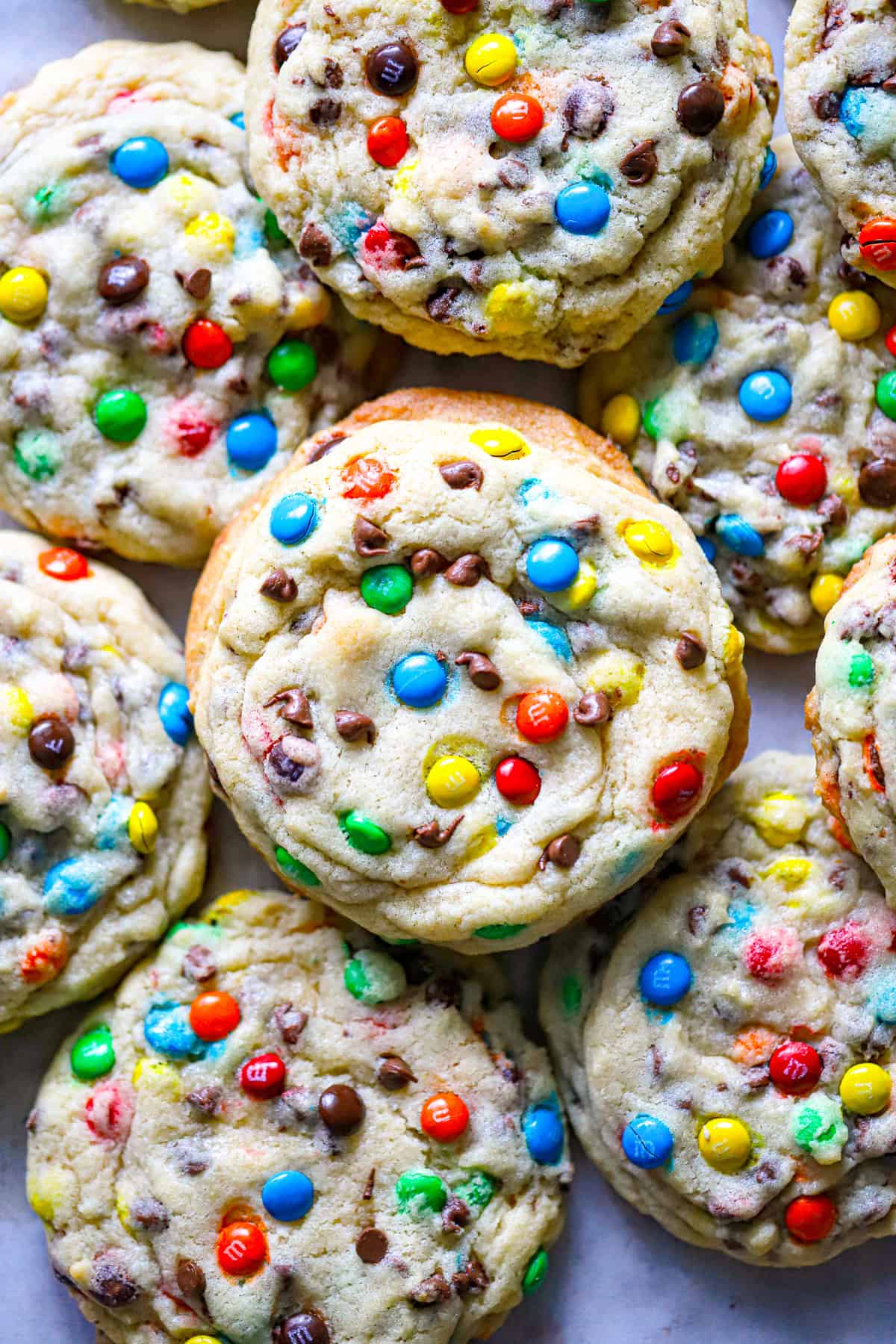 Our Ultimate Super Thick Mini M&M & Chocolate Chip Cookies recipe is one of the best gooey chewy & thickest bakery cookies with crispy edges!