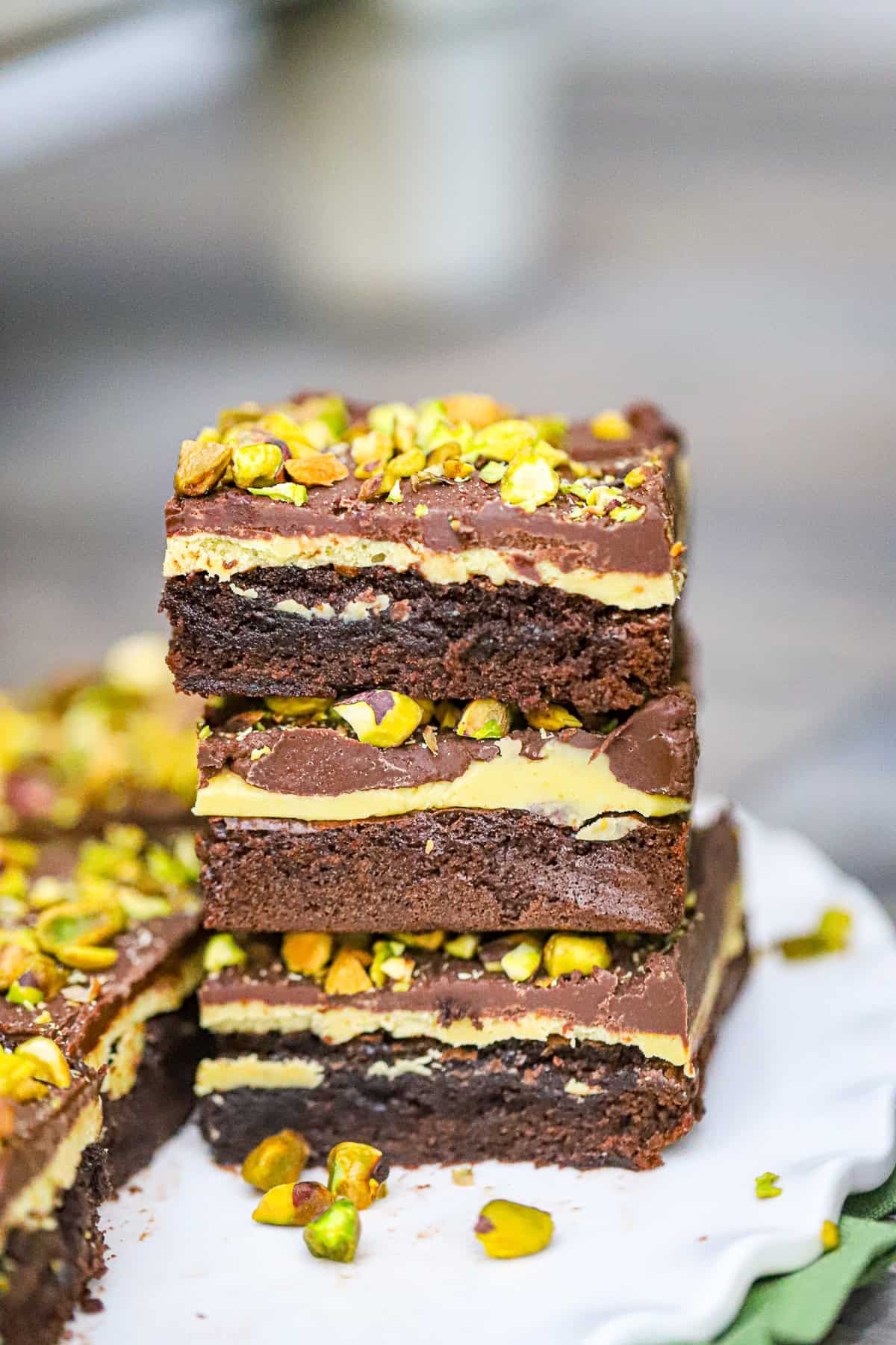 Our decadent Pistachio Brownies recipe is the best! Imagine biting into a fudgy and moist brownie, only to be surprised by a creamy pistachio white chocolate ganache filling. And just when you thought it couldn't get any better, a layer of smooth chocolate ganache and crunchy pistachios on top. Are you drooling yet?