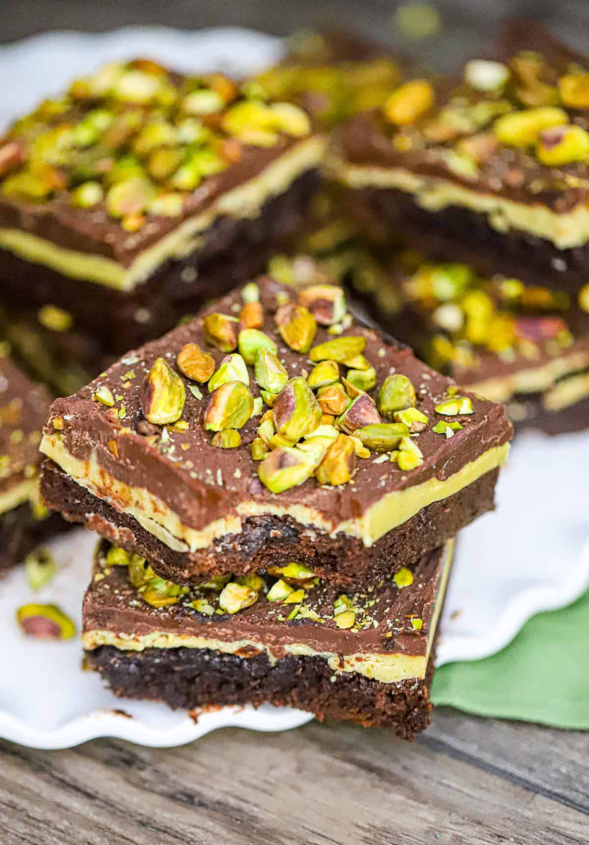 Our decadent Pistachio Brownies recipe is the best! Imagine biting into a fudgy and moist brownie, only to be surprised by a creamy pistachio white chocolate ganache filling. And just when you thought it couldn't get any better, a layer of smooth chocolate ganache and crunchy pistachios on top. Are you drooling yet?